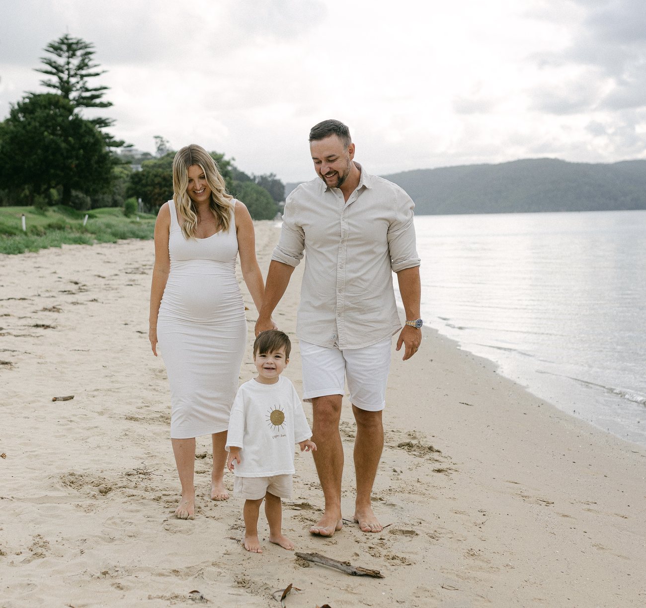 Daniel and Sophie Walsh walking on the beach with their family